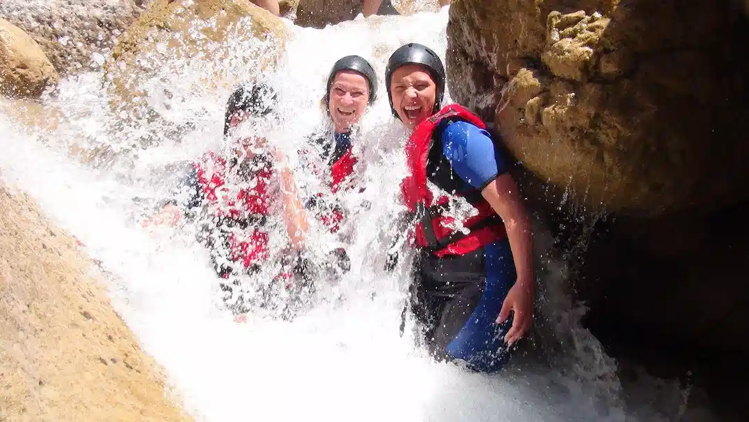 Smiling client wearing rafting gear and helmet
